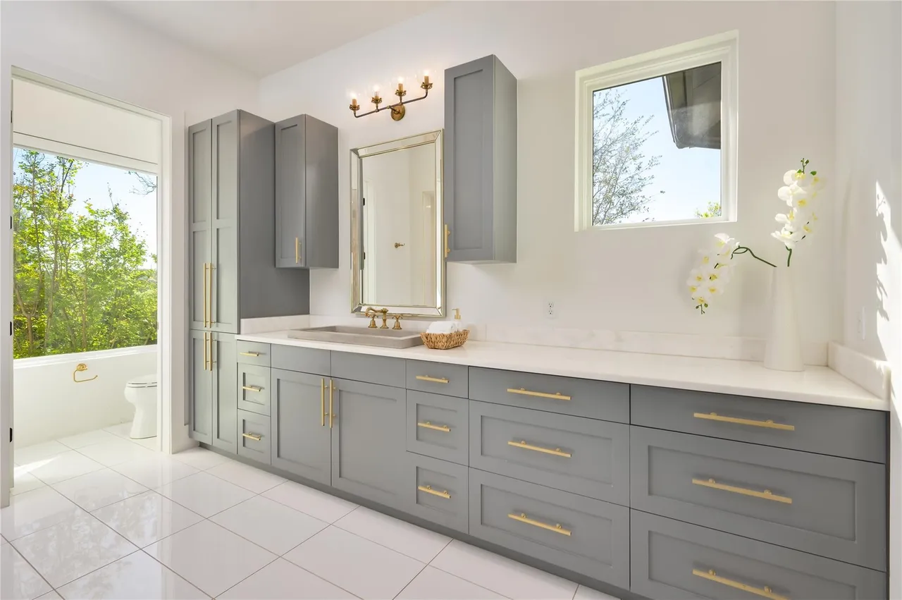 Elegant bathroom vanity with gold fixtures and natural light